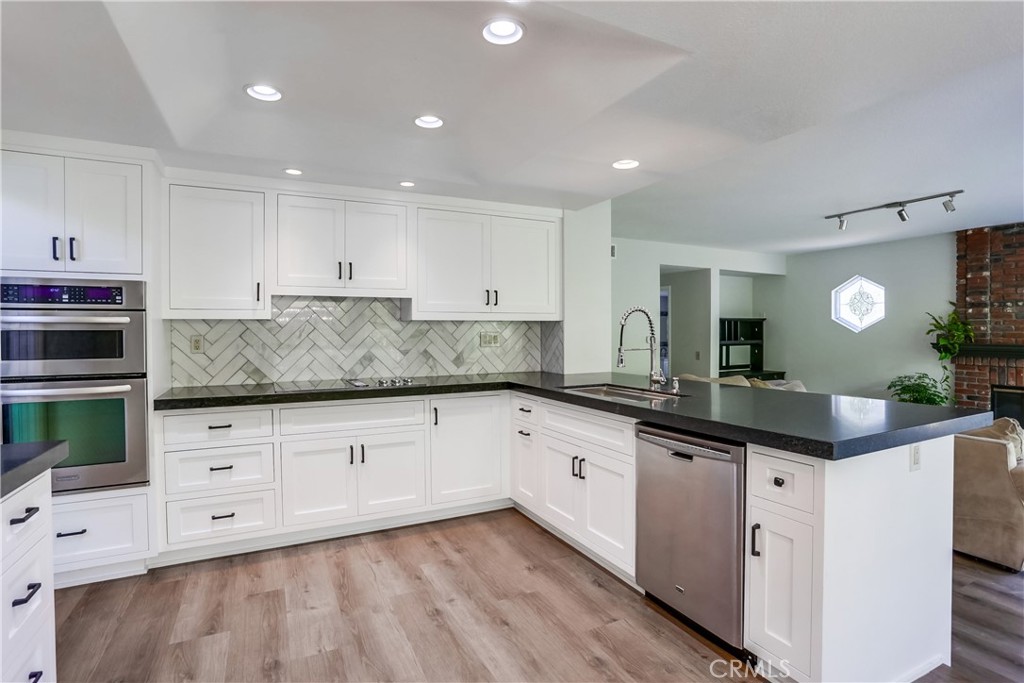 26511 Maside Mission Viejo, CA 92692 - Photo 12 of 46 a kitchen with granite countertop a sink and cabinets