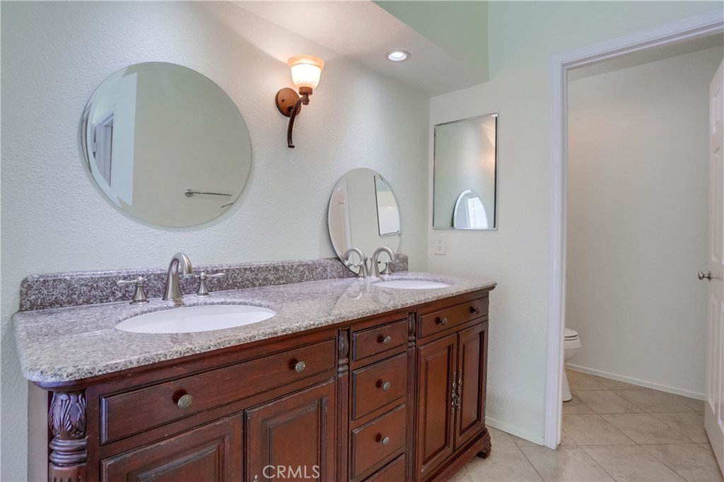 26511 Maside Mission Viejo, CA 92692 - Photo 23 of 46 a bathroom with a granite countertop sink a mirror and a