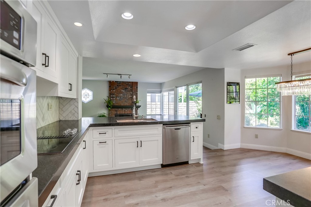 26511 Maside Mission Viejo, CA 92692 - Photo 9 of 46 a large kitchen with granite countertop a large counter top space a sink stainless steel appliances and cabinets