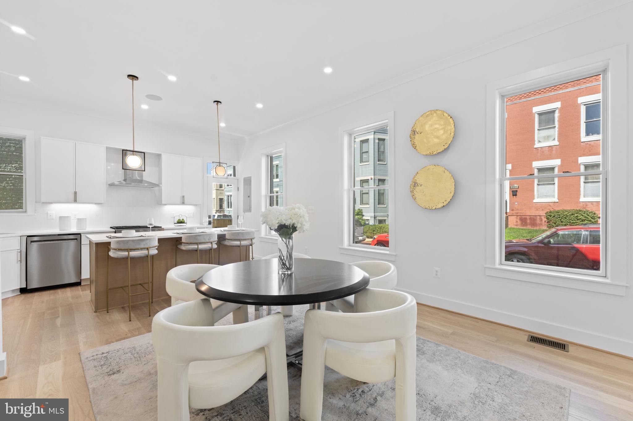 600 U Street Northwest Washington, DC 20001 - Photo 13 of 54 a kitchen with a dining table chairs and microwave
