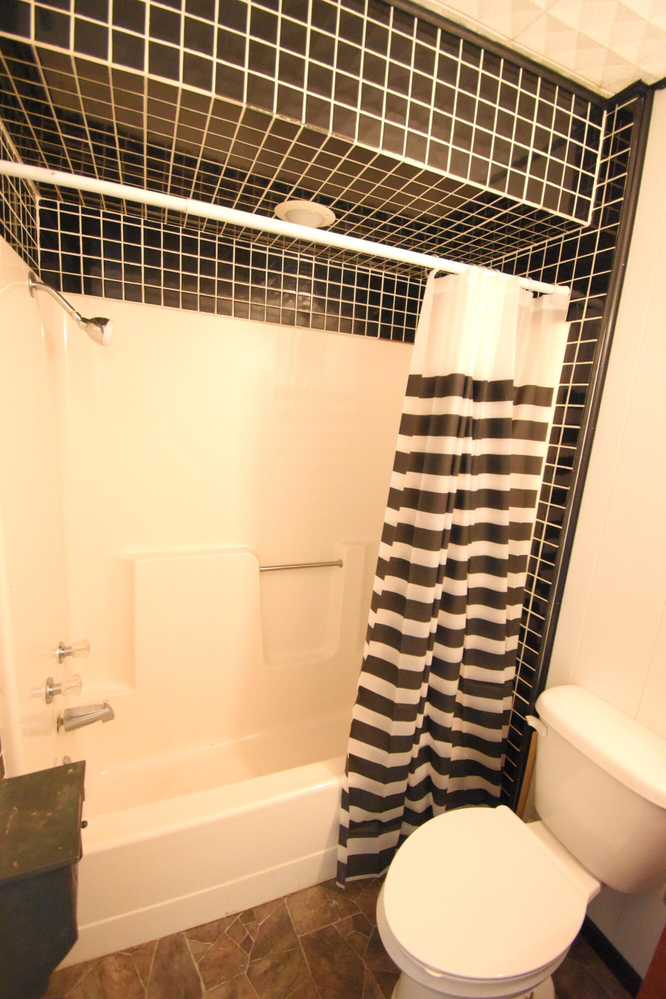 720 North Jefferson Street Rensselaer, IN 47978 - Photo 17 of 49 a bathroom with a toilet and a bathtub