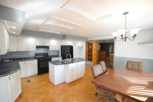a kitchen with sink refrigerator and microwave