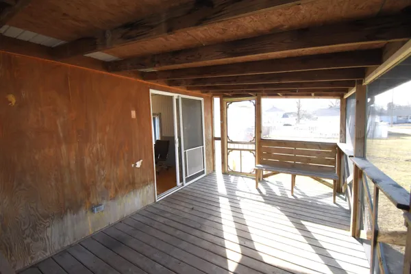 a view of a porch with wooden floor