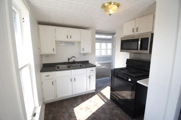 a kitchen with a sink stove and microwave