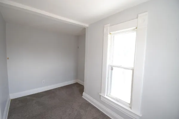 a view of an empty room and a window