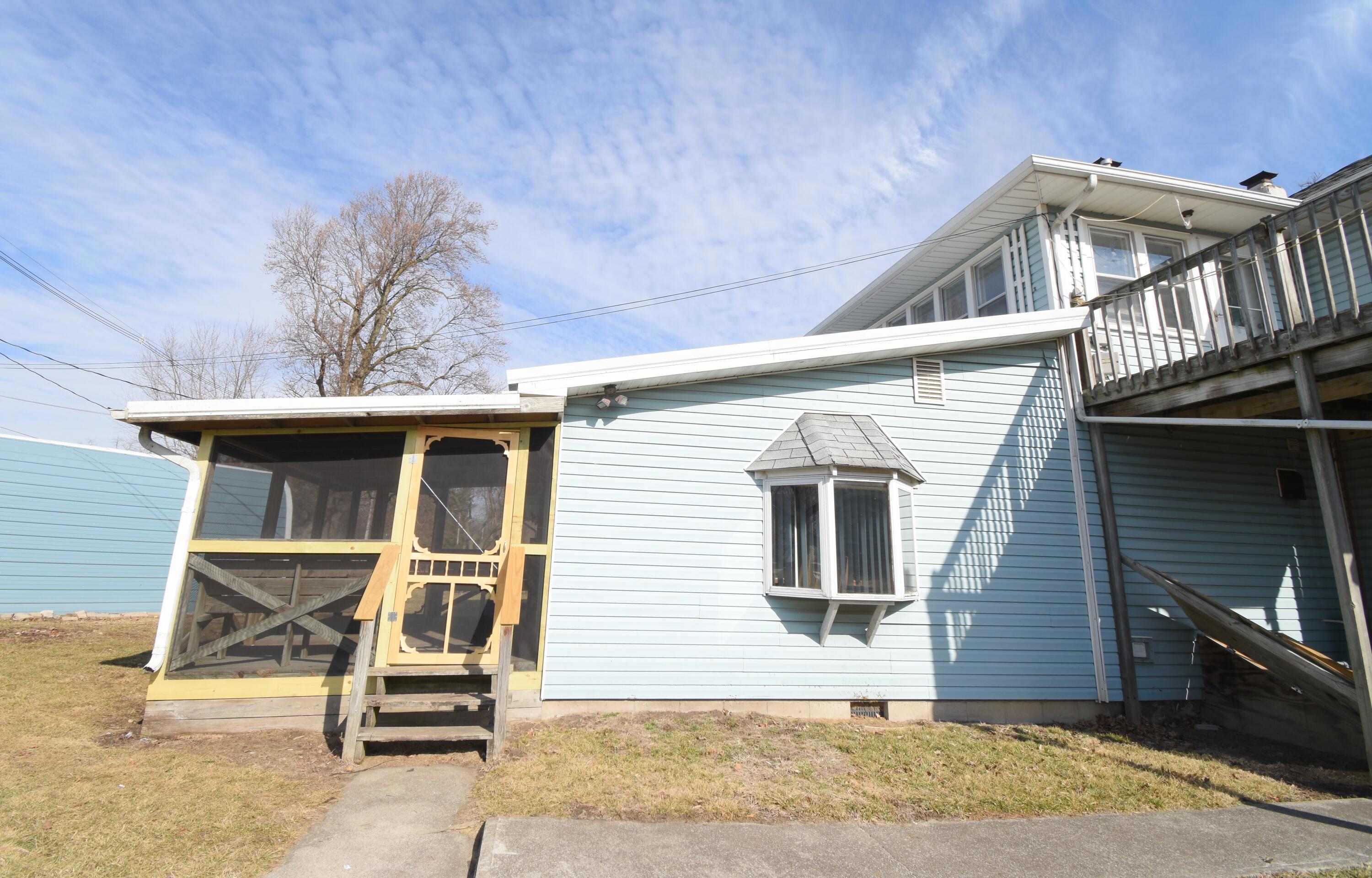 720 North Jefferson Street Rensselaer, IN 47978 - Photo 8 of 49 a view of a house with a yard and wooden fence