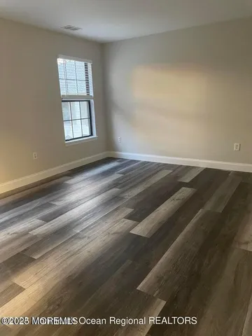an empty room with wooden floor