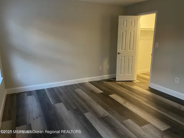 a view of a room with wooden floor