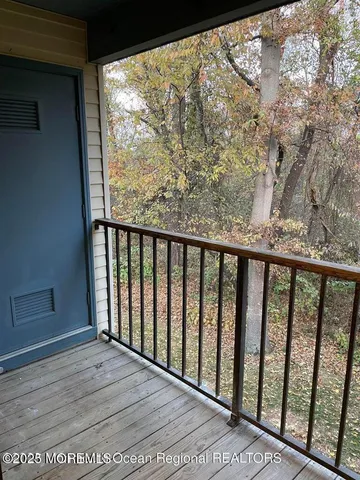 a view of a balcony with wooden floor