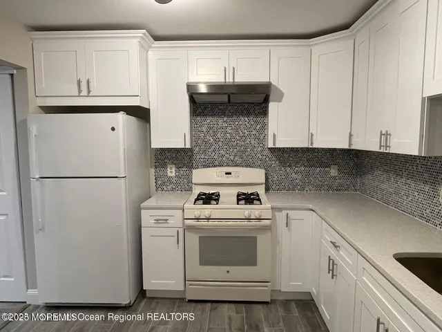 a kitchen with a white cabinets and white appliances
