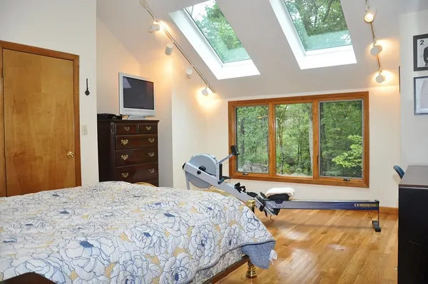 a bedroom with a bed and a large window
