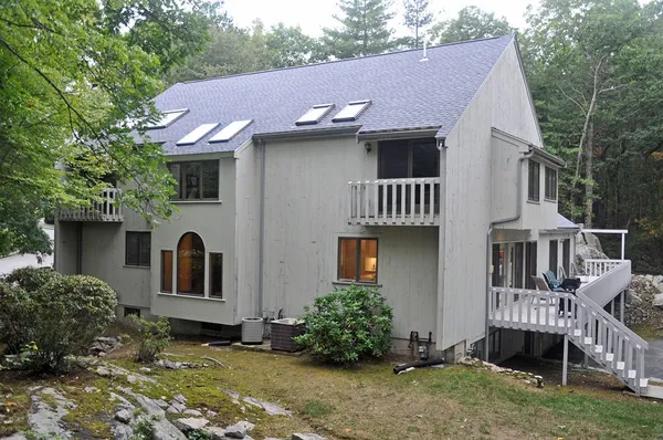a front view of a house with garden