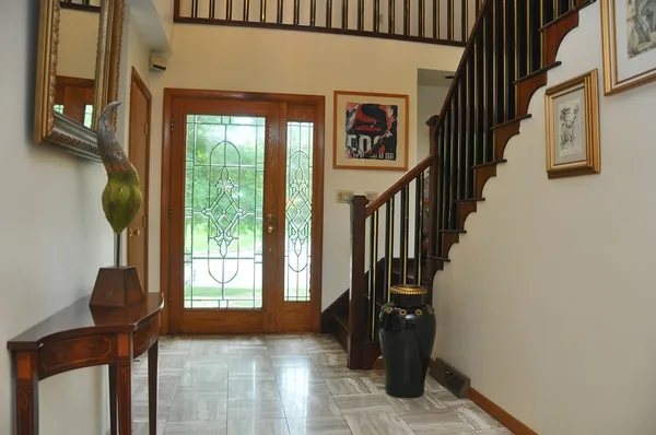 a view of entryway and hall with wooden floor