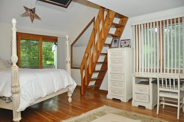 a bedroom with a bed and a large window