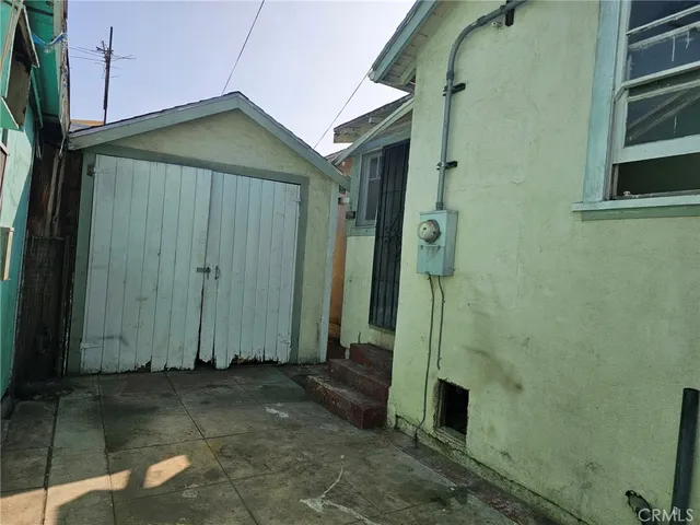 a view of a tall building next to a yard