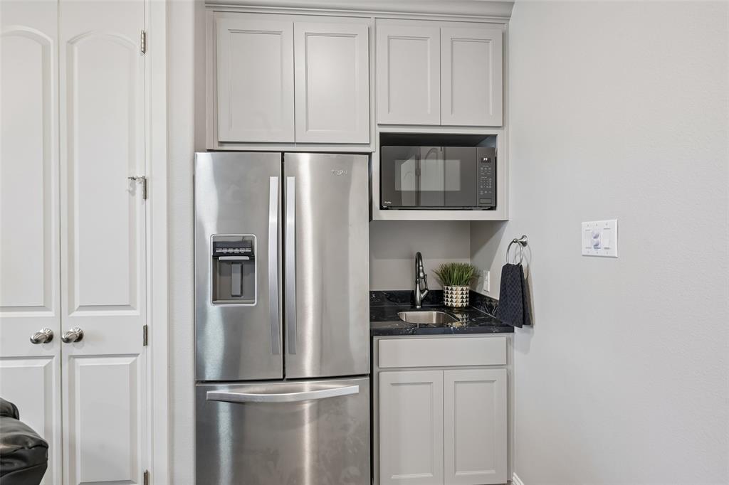 1657 Florence Road Keller, TX 76262 - Photo 24 of 40 a kitchen with a refrigerator and cabinets