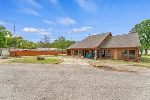 a view of a house with a yard and sitting area