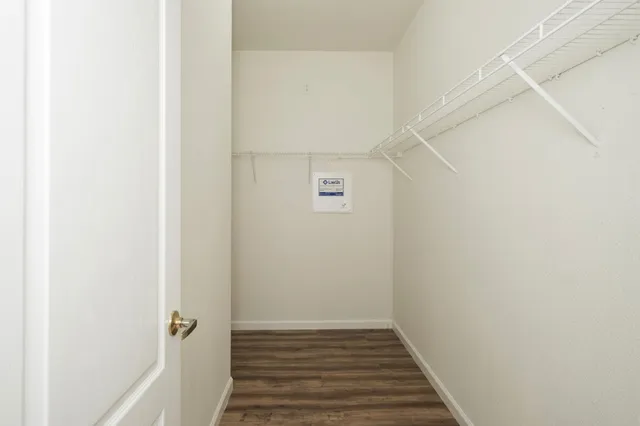 a view of a room with wooden floor