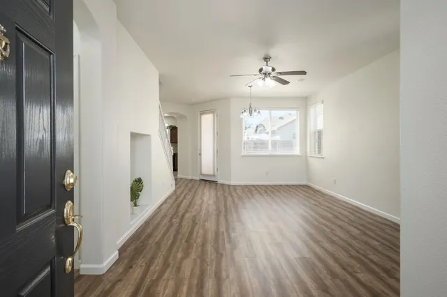 wooden floor in an empty room with a window