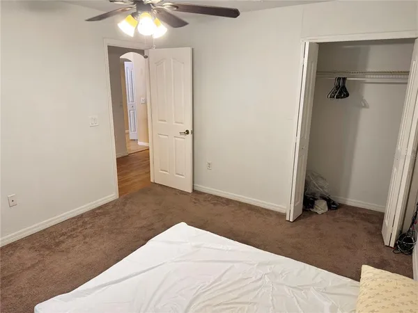 a living room with furniture and ceiling fan