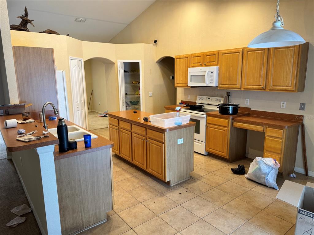 12055 Robina Road Weeki Wachee, FL 34614 - Photo 18 of 64 a kitchen with stainless steel appliances granite countertop a stove and a sink