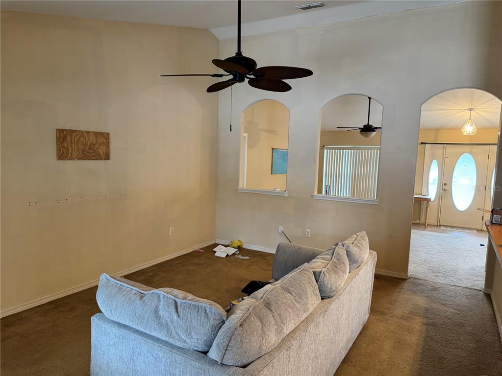 12055 Robina Road Weeki Wachee, FL 34614 - Photo 20 of 64 a living room with furniture and a chandelier