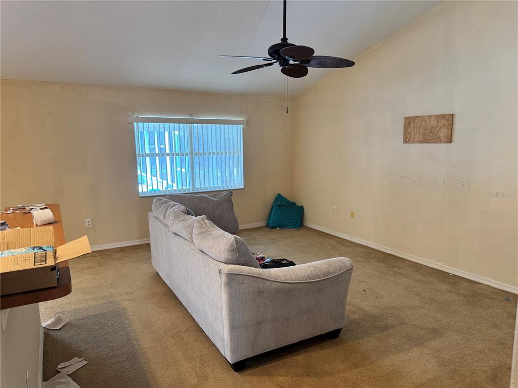 12055 Robina Road Weeki Wachee, FL 34614 - Photo 21 of 64 a living room with furniture and ceiling fan