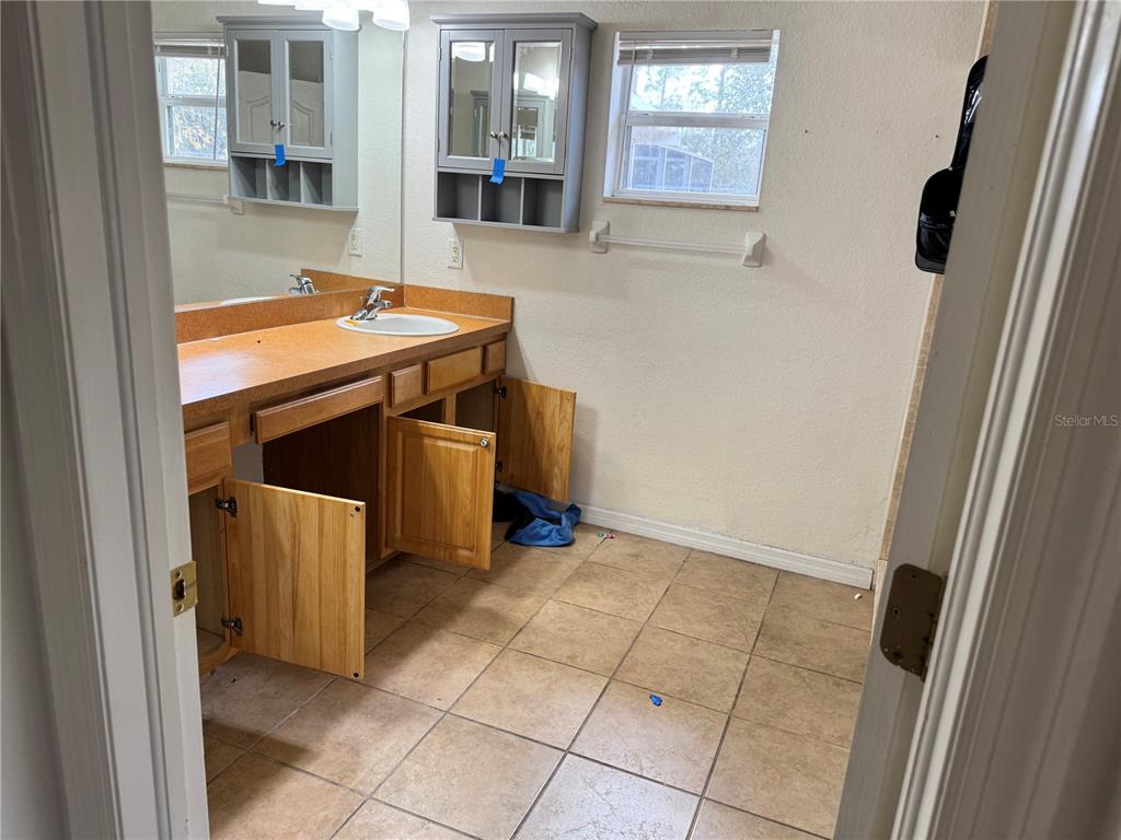 12055 Robina Road Weeki Wachee, FL 34614 - Photo 30 of 64 a utility room with dryer and washer