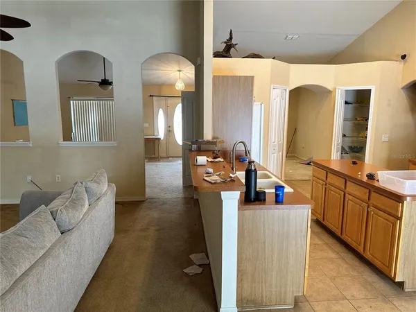 a view of a backyard with swimming pool and sitting area