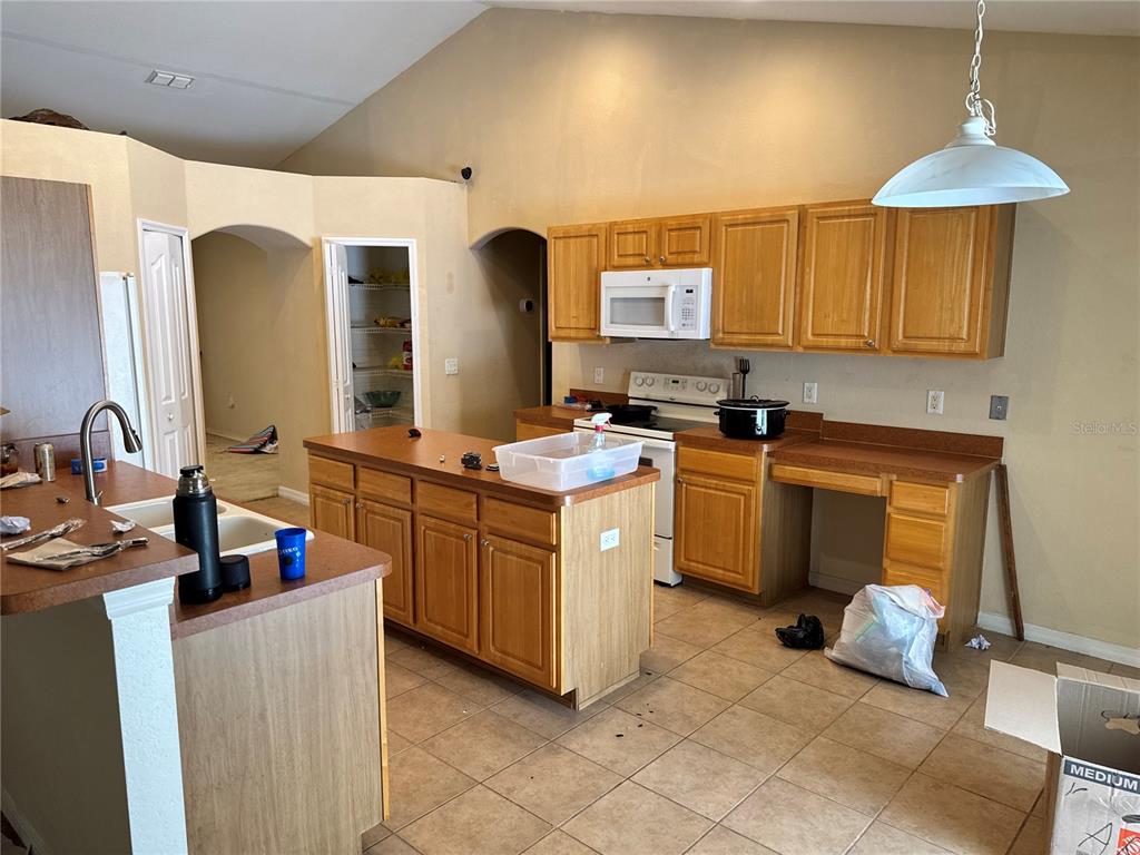 12055 Robina Road Weeki Wachee, FL 34614 - Photo 35 of 64 a kitchen with a sink stove and cabinets