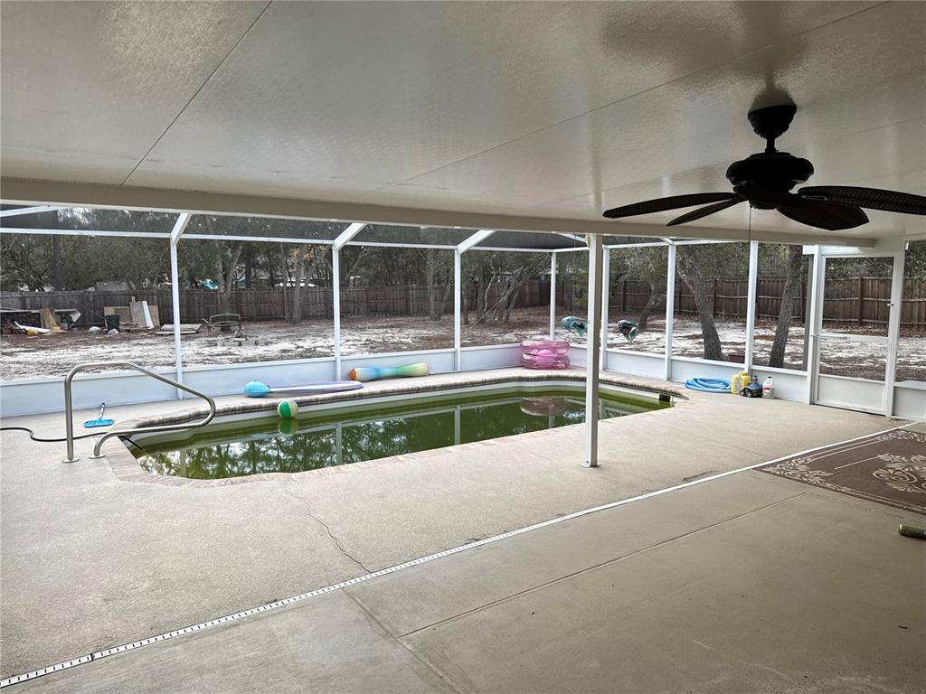 12055 Robina Road Weeki Wachee, FL 34614 - Photo 38 of 64 a view of a swimming pool with a lawn chairs and couches