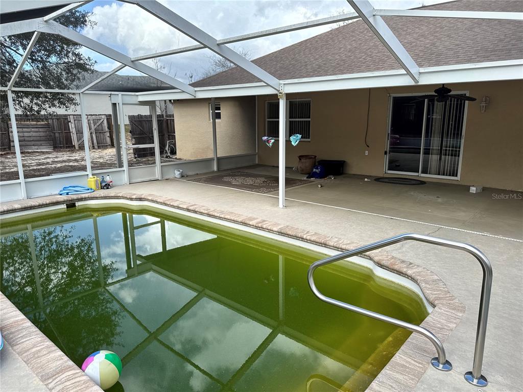 12055 Robina Road Weeki Wachee, FL 34614 - Photo 41 of 64 a swimming pool with outdoor seating and yard