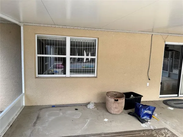 a view of a backyard with wooden fence and a large tree