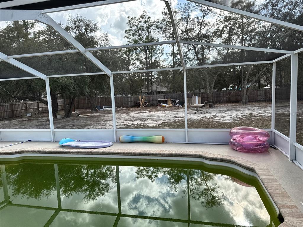 12055 Robina Road Weeki Wachee, FL 34614 - Photo 46 of 64 a view of a backyard with swimming pool and sitting area