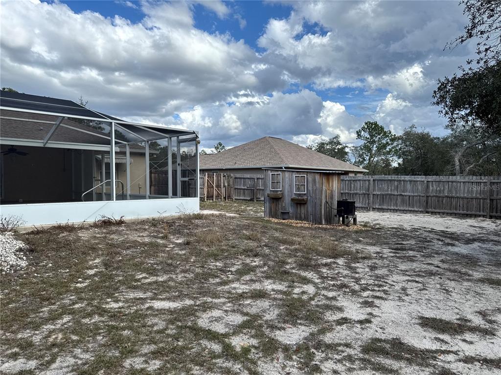 12055 Robina Road Weeki Wachee, FL 34614 - Photo 54 of 64 a view of a house with a yard