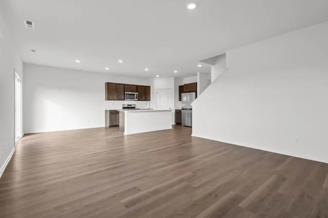 a view of an empty room and closet area