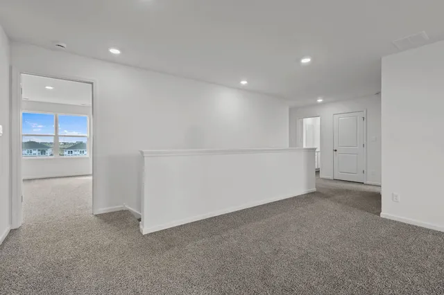a dining room with furniture a rug and a floor to ceiling window