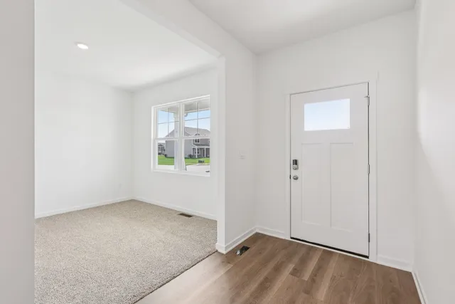 a kitchen with stainless steel appliances granite countertop a sink a stove and a refrigerator