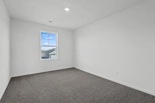 a kitchen with stainless steel appliances kitchen island granite countertop a refrigerator a stove a sink a dining table and chairs with wooden floor