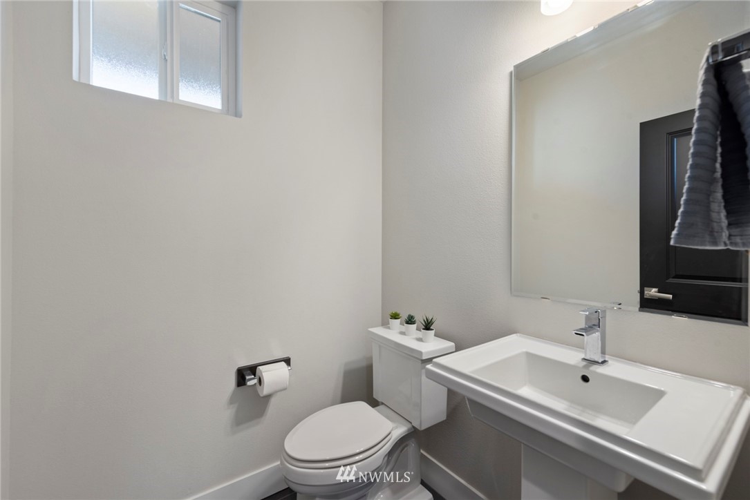 20619 3rd Avenue Southeast Bothell, WA 98012 - Photo 10 of 28 a bathroom with a toilet a sink and mirror