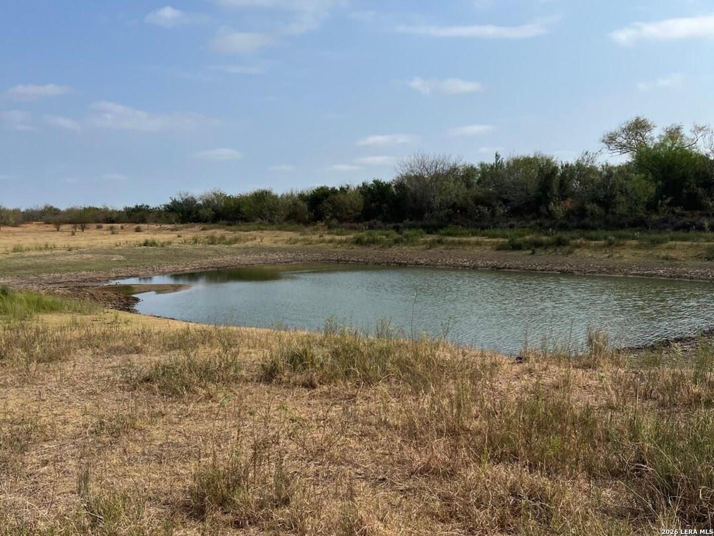 a view of lake with green field