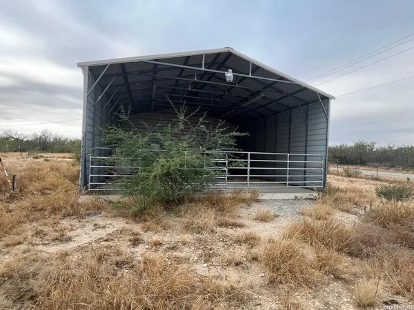 a view of backyard with wooden fence and a tub