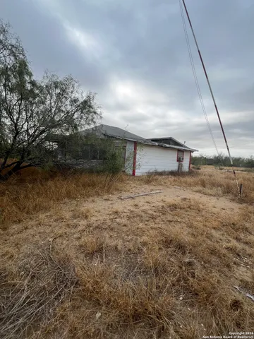 a view of a hardwood floor and a tree