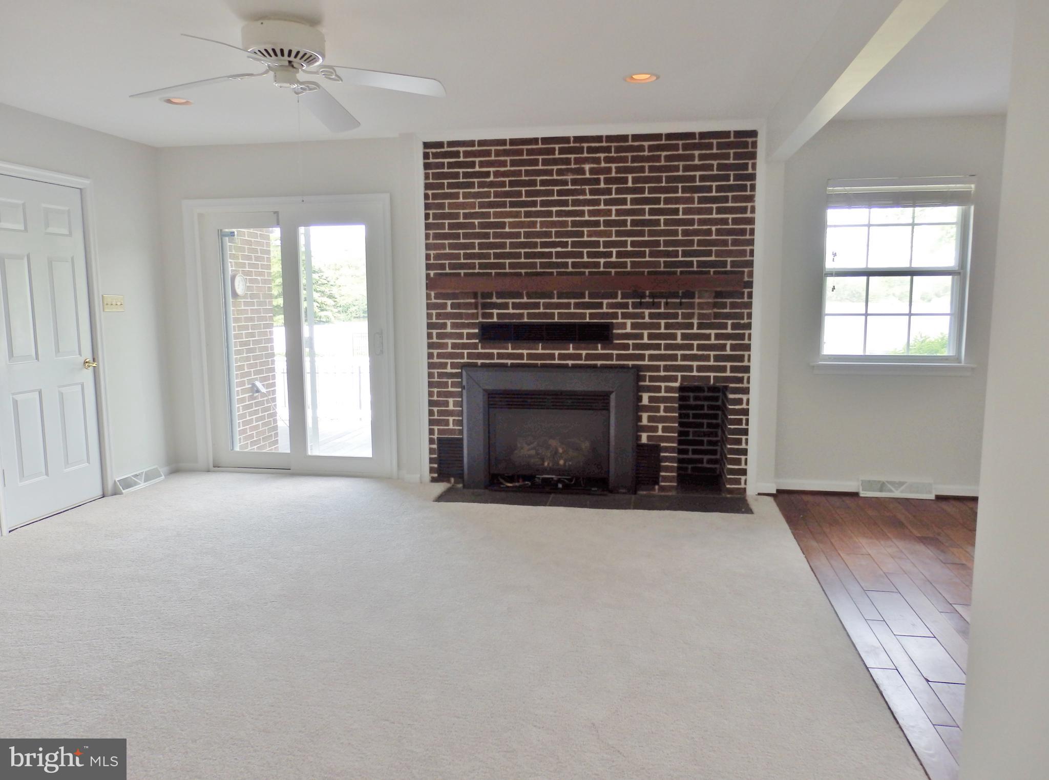 49945 Fenwick's Pride Lane Ridge, MD 20680 - Photo 17 of 64 Family Room with exit to deck and gas FP