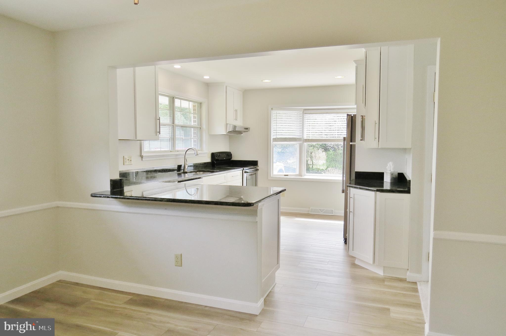 49945 Fenwick's Pride Lane Ridge, MD 20680 - Photo 29 of 64 Open Kitchen w/Breakfast Bar to Dining Room