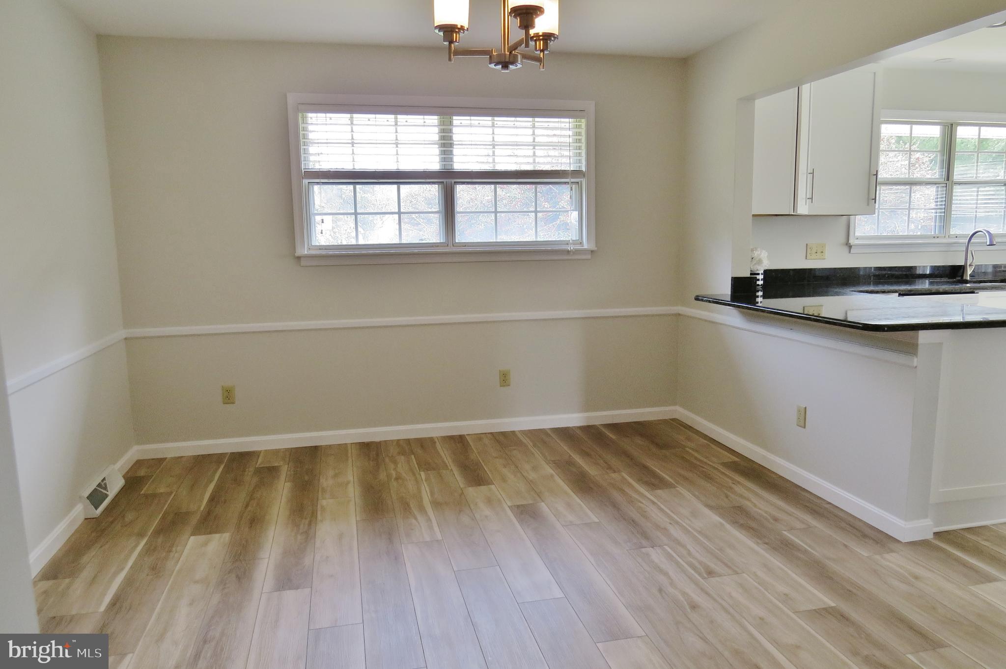 49945 Fenwick's Pride Lane Ridge, MD 20680 - Photo 30 of 64 New Flooring in Open Kitchen & Dining Room