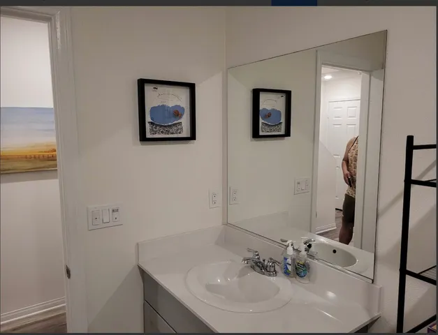 a bathroom with a sink and a mirror