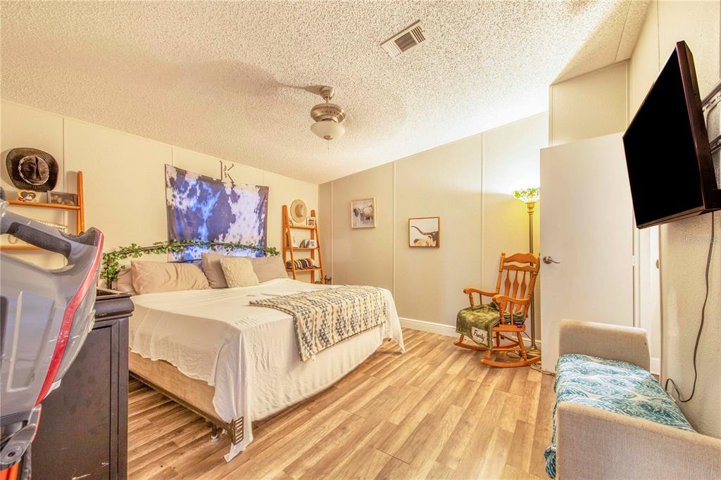2747 Old Bartow Road Lake Wales, FL 33859 - Photo 13 of 30 a spacious bedroom with a bed and a flat screen tv