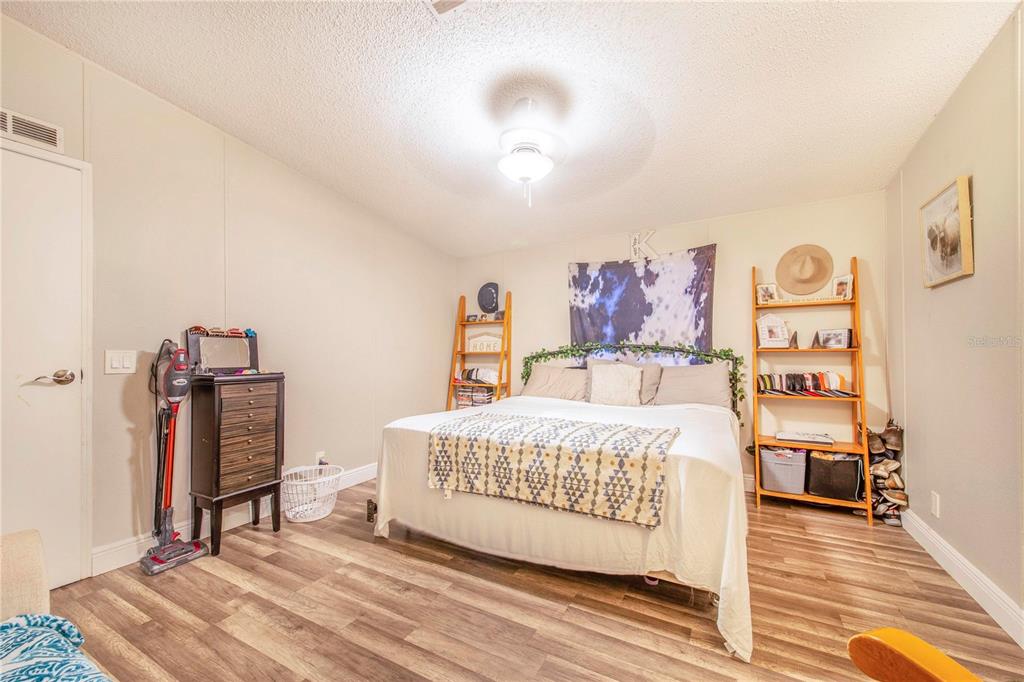 2747 Old Bartow Road Lake Wales, FL 33859 - Photo 14 of 30 a bedroom with a bed and a dresser in it