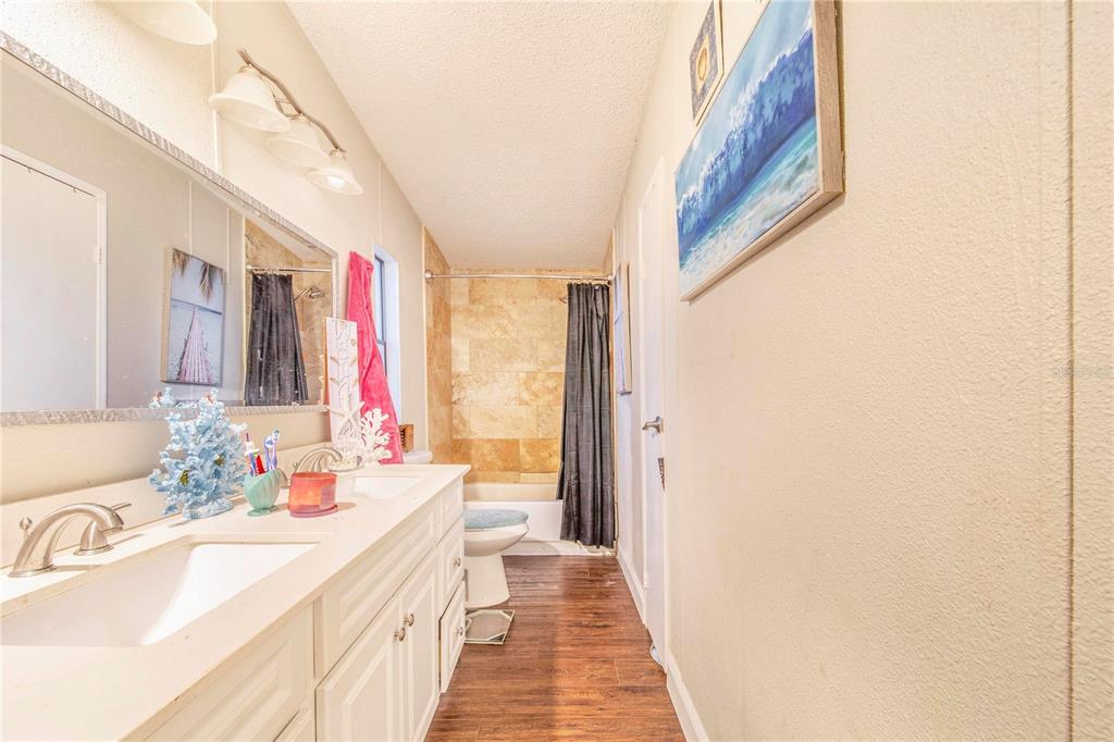 2747 Old Bartow Road Lake Wales, FL 33859 - Photo 15 of 30 a bathroom with a sink a mirror and a shower